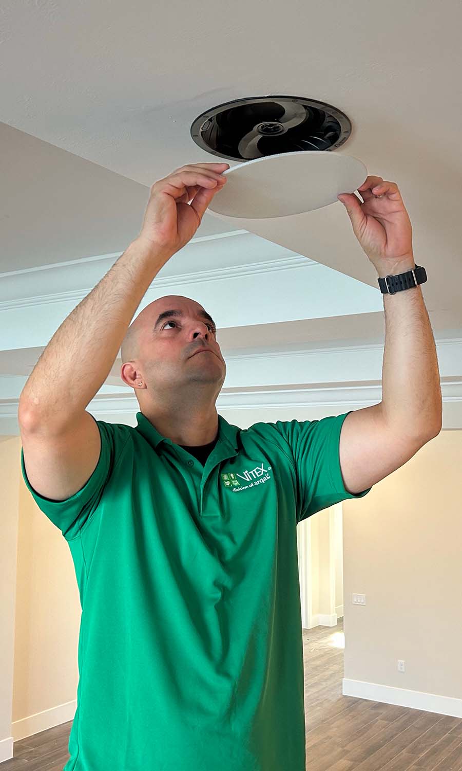 Vitex technician installing TV wall plates and terminating structured wiring after drywall